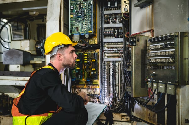Control-Panel-Wiring_Technician-checking-operation-of-production-machinery-cabinet-in-industrial factory