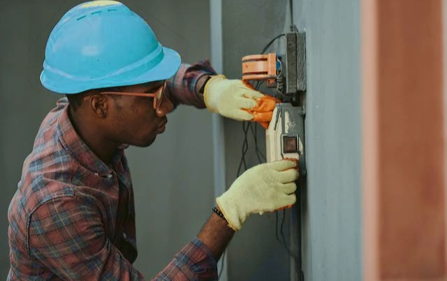Industrial-fuse-types-Electrician-servicing-box