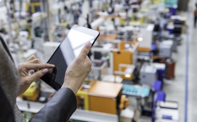 New-networking-equipment-Manager-researching-online-in-factory
