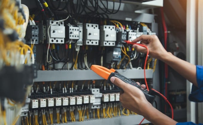 Relay-selection-guide_Electrician-measuring-current-in-panel